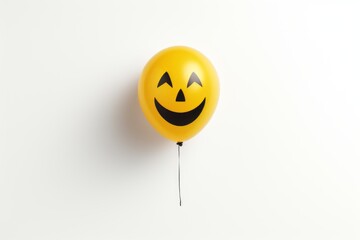 Yellow balloon with a smiley face on white background