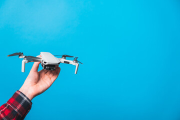 Drone quadcopter for aerial footage isolated in blue background 