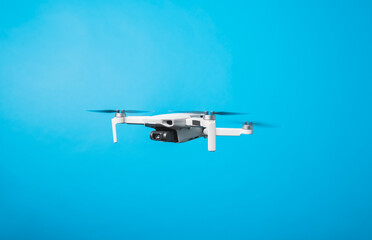 Drone quadcopter for aerial footage isolated in blue background 