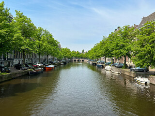 Fototapeta na wymiar Canals of Amsterdam During the Day in Spring in the Netherlands