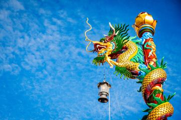 Statue of a dragon slithering around a thousand pillars in the Thapthim Shrine, Ban Na Kluea...
