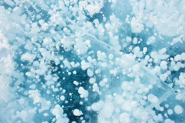 Baikal ice, pure blue ice with methane bubbles. Natural ice background.