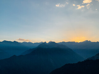 Fototapeta na wymiar Beautiful alpine landscape with mountain range silhouette. Mountain peaks in the Alps.