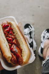 Delicious hot dog in male hand in Toronto, Canada. 