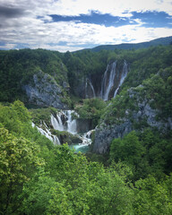 Fototapeta premium Scenic view of the waterfall in the mountain forest near Plitvička Jezera, Croatia, May 2019