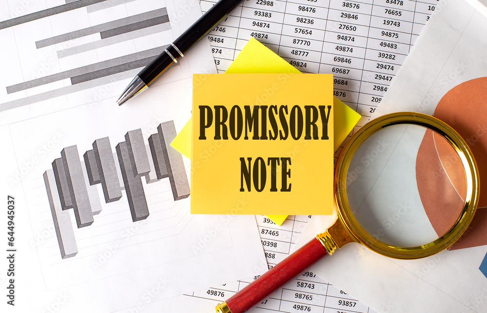 Aufkleber promissory note text on a sticky on red notebook on chart background