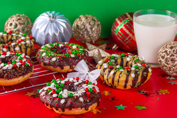 Bright festive decorated Christmas and New Year donuts set, with colorful red, green white snowflake sugar sprinkles. Sweet seasonal Christmas dessert