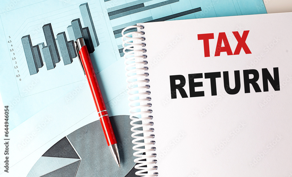 Poster tax return text on a notebook with pen on a chart background