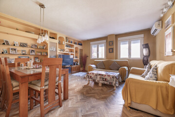 A living room full of wooden furniture with a built-in bookcase with niches