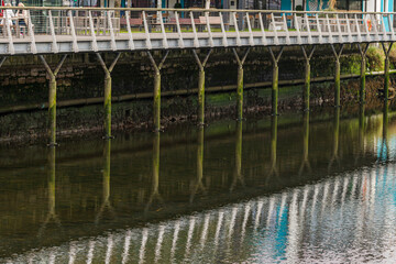 Posts full of seaweed on the promenade over the River Liffey in Dublin, Ireland