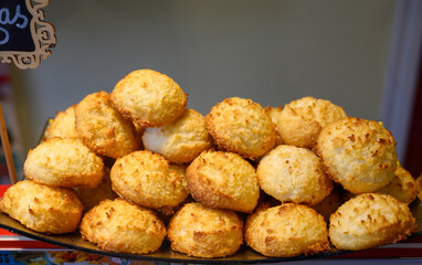 Fresh baked pastries and sweets on display in artisan Spanish confectionery shop, coconut cakes