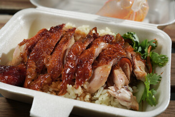 Malaysian take away local delicacy - Roasted Chicken Rice in polystyrene container. 