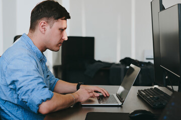 Portrait professional man programmer working concentrated on computer diverse offices. Modern IT technologies, development of artificial intelligence, programs, applications and video games concept