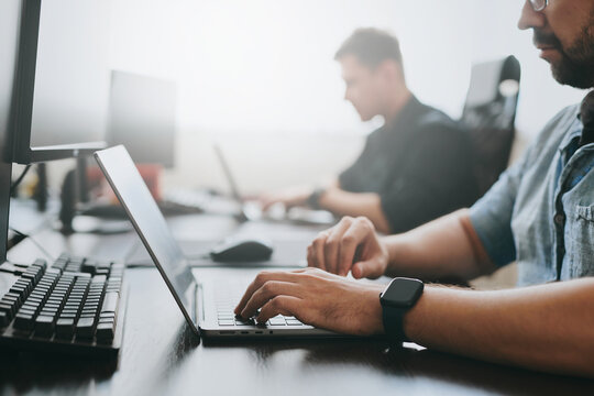 Portrait of two professional male programmers working on computer in diverse offices. Modern IT technologies, development of artificial intelligence, programs, applications and video games concept
