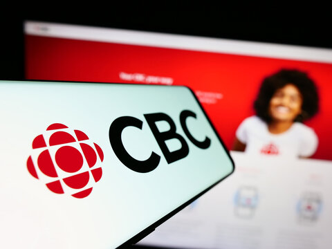 Stuttgart, Germany - 08-30-2023: Cellphone with logo of Canadian Broadcasting Corporation (CBC) on screen in front of website. Focus on center-left of phone display.