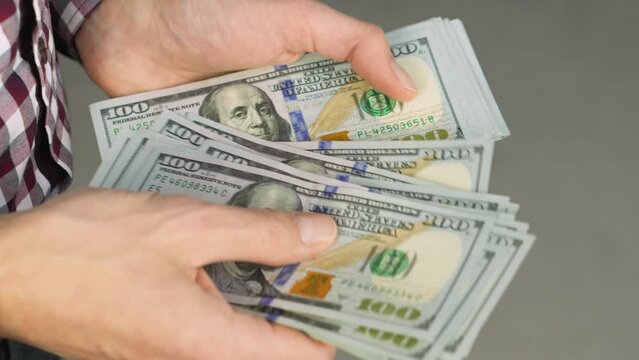 Group dollar bills gives impression financial wealth and great opportunities for business and investment. man carefully counts banknotes, reflecting the ability to manage finances and make payments.