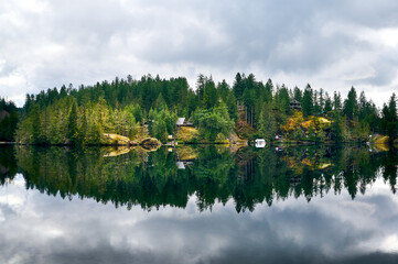 Beautiful crystal clear Ruby Lake in Sunshine Coast of British Columbia. Сoastal rainforest with cedars and firs. Dan Bosch Park. Sunshine Coast Highway. BC, Canada