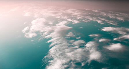 Naklejka premium Beautiful and colourful landscape of sunset or sunrise with white clouds, blue green sky with pastel pink color. Natural abstract background. Panoramic banner view.