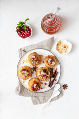 Baked stuffed sweet apples served on ceramic plate