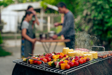 BBQ Fun Party with Grandparents, Family Gathering in the Garden, Summertime with grandpa, grandma, father and mother, BBQ Grill