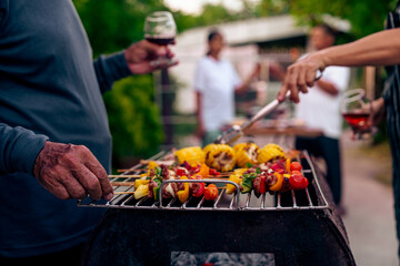 BBQ Fun Party with Grandparents, Family Gathering in the Garden, Summertime with grandpa, grandma, father and mother, BBQ Grill