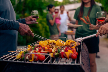 BBQ Fun Party with Grandparents, Family Gathering in the Garden, Summertime with grandpa, grandma, father and mother, BBQ Grill