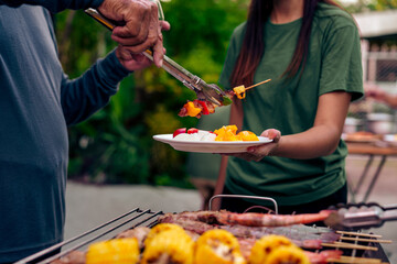 BBQ Fun Party with Grandparents, Family Gathering in the Garden, Summertime with grandpa, grandma, father and mother, BBQ Grill