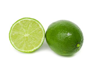 Fresh green lemons and lime leaves placed on a white background.