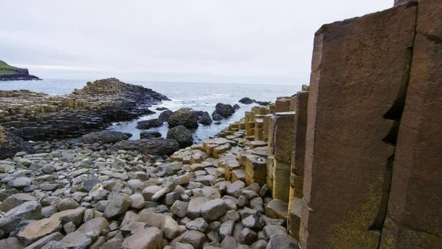 Giant Causeway ocean cliff with shoreline in the distance. Ireland.