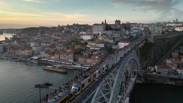 Aerial view of train on Dom Luis I Bridge between Porto and Vila Nova de Gaia at dusk, Porto (Oporto), Portugal.