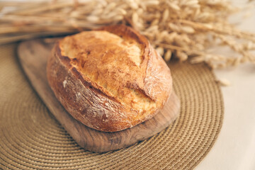 Freshly baked traditional bread. Wheat bakery products on a wooden board with space for copying. High quality photo