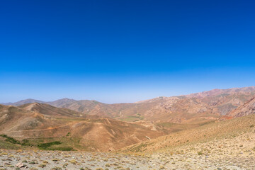 Hindu Kush in Central Afghanistan, an arid landscape where semi nomadic tribes herd cattle and grow crops in marginal and harsh environment.