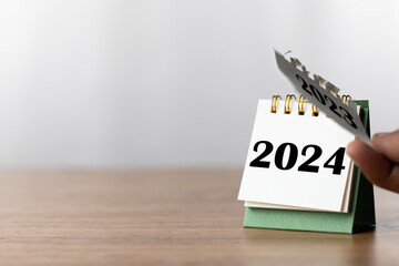 2024 Happy New year background. Turns over a calendar sheet.  Setup objective target business cost...