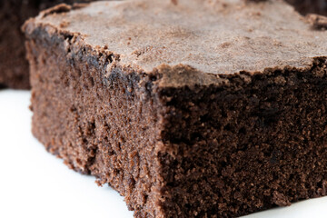 Chocolate brownie portions on wooden background