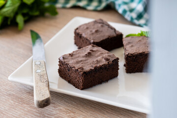 Chocolate brownie portions on wooden background