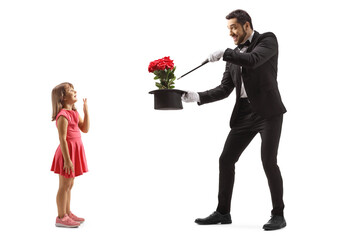 Full length profile shot of a girl watching a magician performing a trick