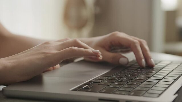 Female Hands Browsing on Laptop Touchpad Close Up
