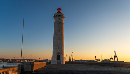 Lighthouse of Môle Saint Louis from the port of Sète, at sunrise, in Hérault, Occitanie, France - obrazy, fototapety, plakaty