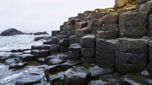Giants Causeway at ocean level with waves crashing lightly