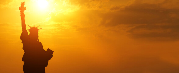 Statue of Liberty silhouette on sunset background. American holiday concept. USA