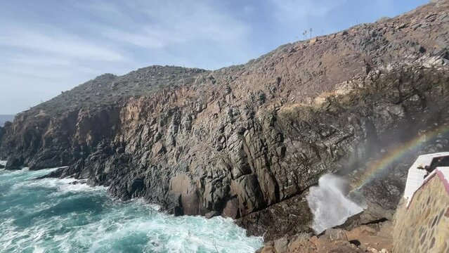 The Bufadora, a marine gesiser with a rainbow in the Mexican city of Ensenada, is a very touristic place in the Baja California of Mexico.