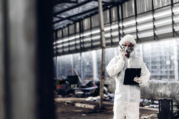 Scientist wear Chemical protection suit check danger chemical, working at dangerous zone in Red and...