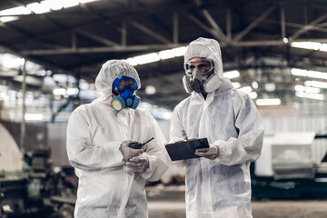Scientist wear Chemical protection suit check danger chemical, working at dangerous zone in Red and...