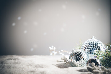 Silver Christmas balls amd snowflakes on shiny background. Christmas greeting card with copy space.