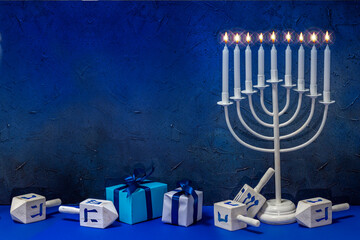 Jewish Hanukkah Menorah 9 Branch Candlestick, dreidel, gift boxes. Holiday Candle Holder, dreidl. Nine-arm candlestick. Traditional Hebrew Festival of Lights candelabra. Background with copy space