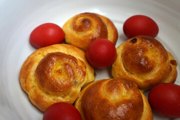 Easter Romanian bun bread. Easter brioche, bread buns and red Easter eggs. Traditional easter food
