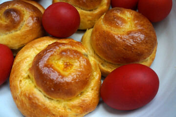 Easter Romanian bun bread. Easter brioche, bread buns and red Easter eggs. Traditional easter food