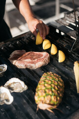 chef preparing food on a grill outside