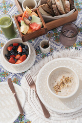 oatmeal breakfast with bowl of berries and green smoothie