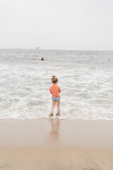 child in the water on the beach 